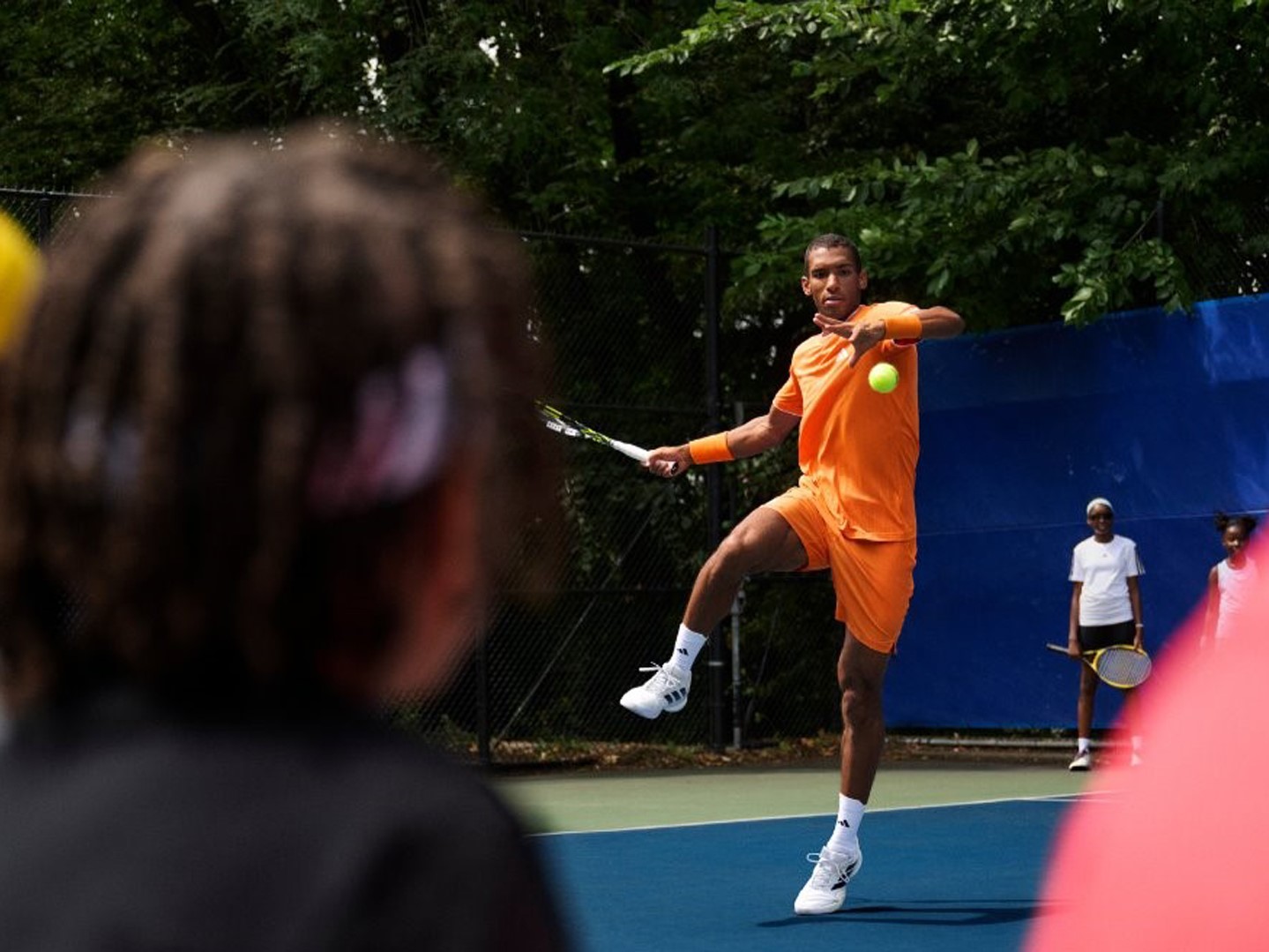 Warming up for the Australian Open has started Fe lix Auger Aliassime training with young opponents wearing new Barrica