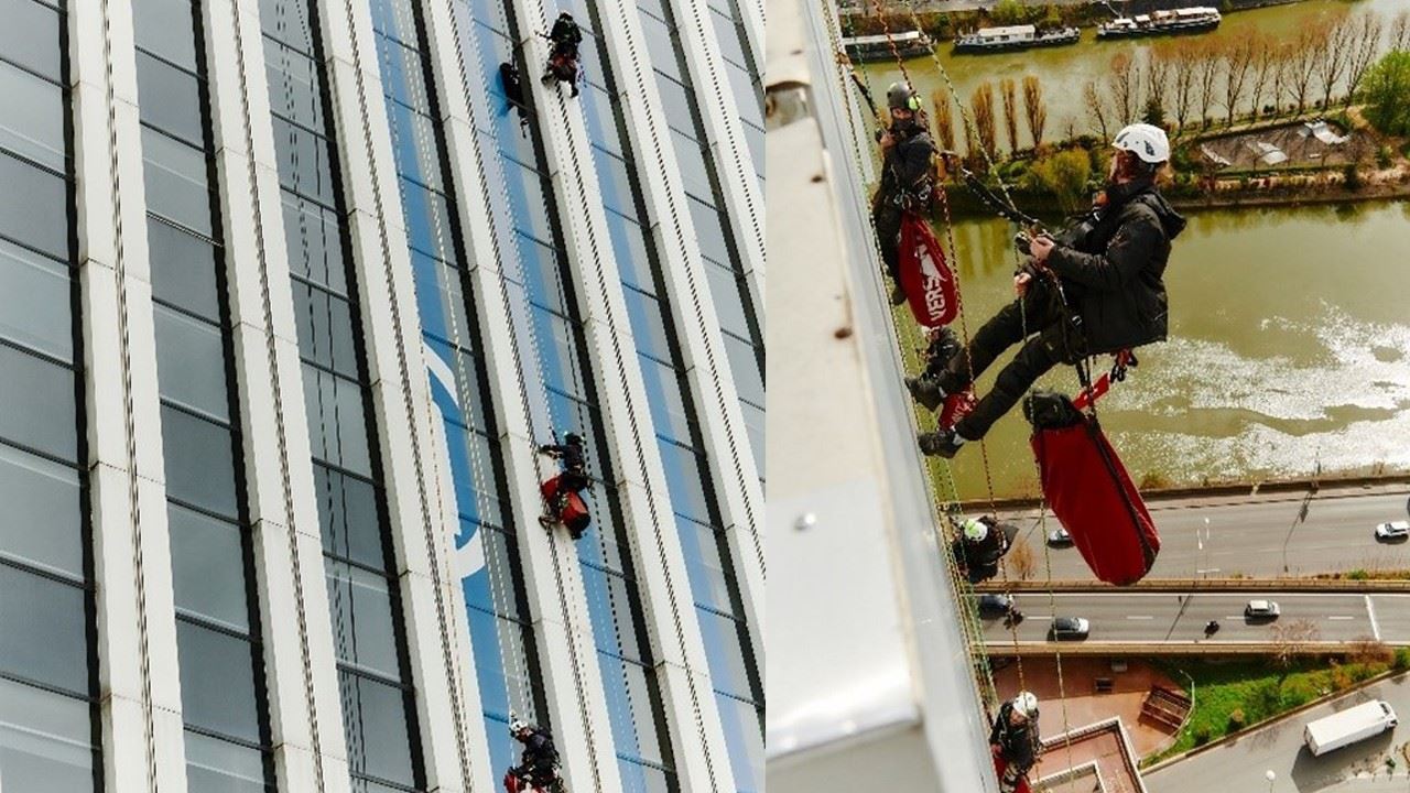 Technicians working hard to display the colours of Paris 2024 on Neptune Tower