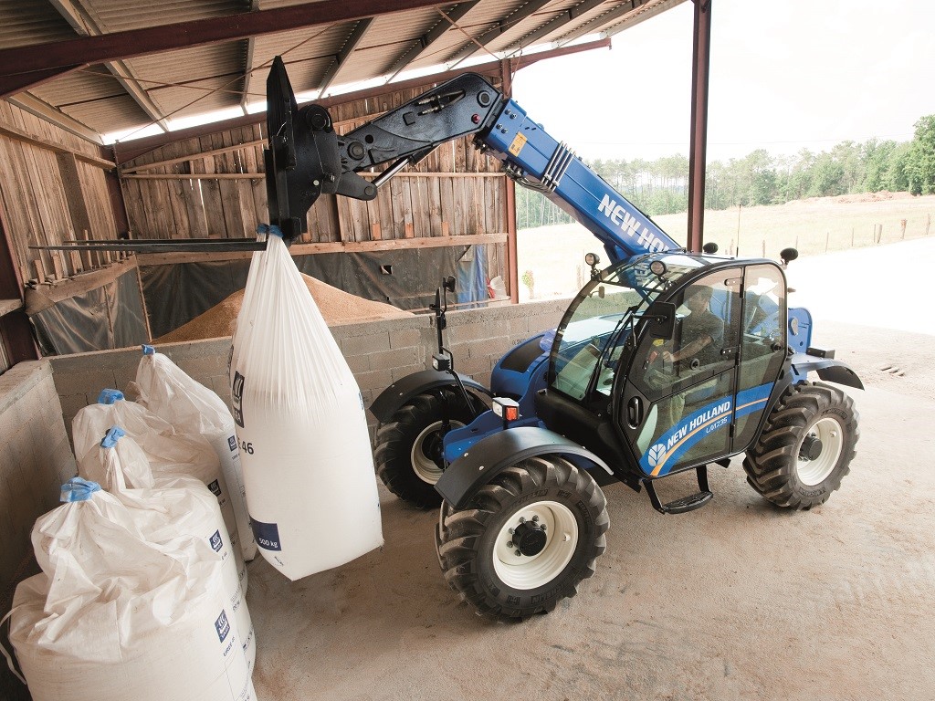 New Holland LM7.35 Telehandler moving fertilizer bags