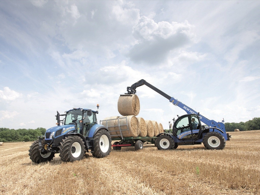 New Holland LM7.35 Telehandler loading bales in the field