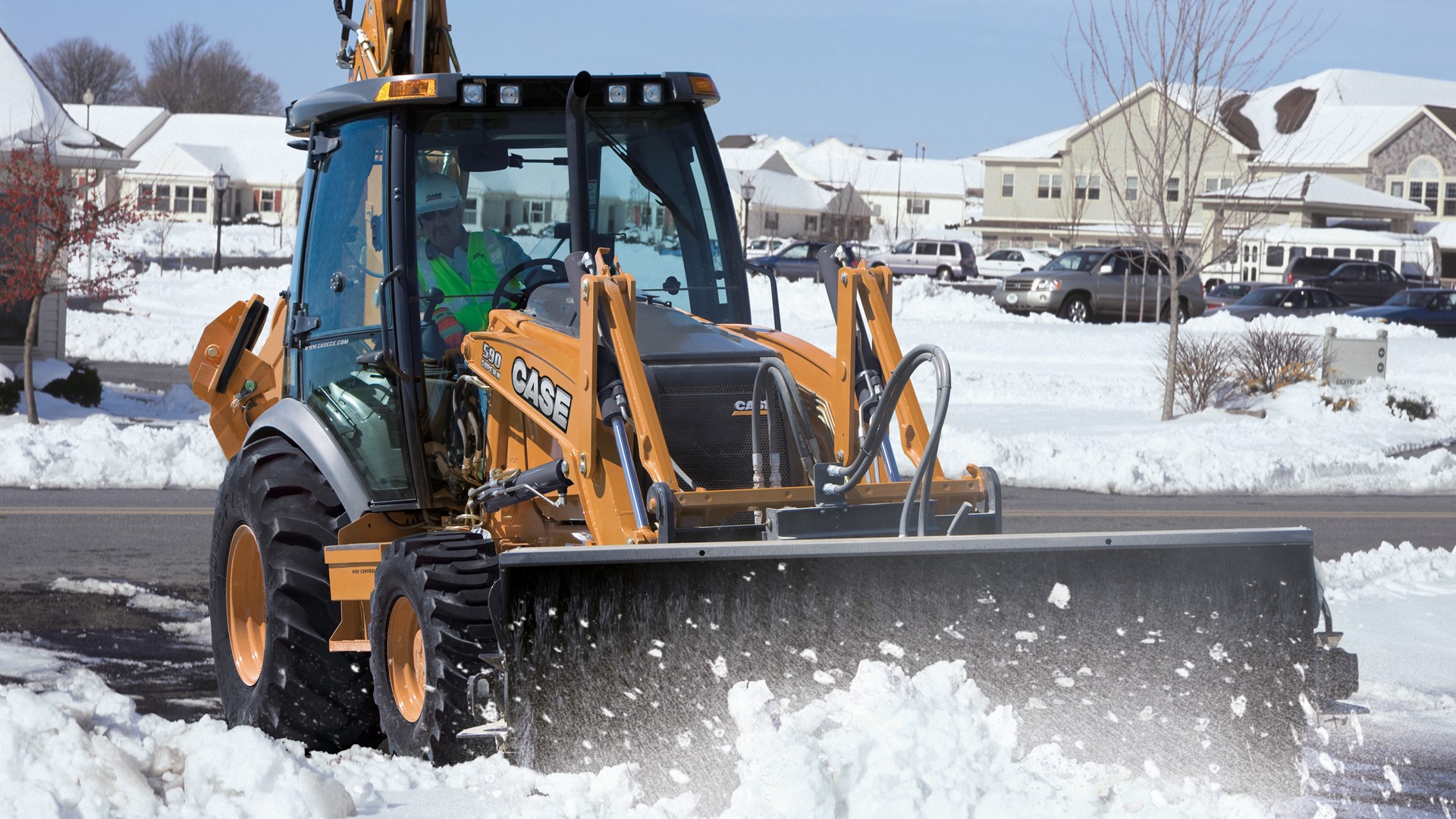 CASE 590 SN Backhoe Loader conducting snow removal