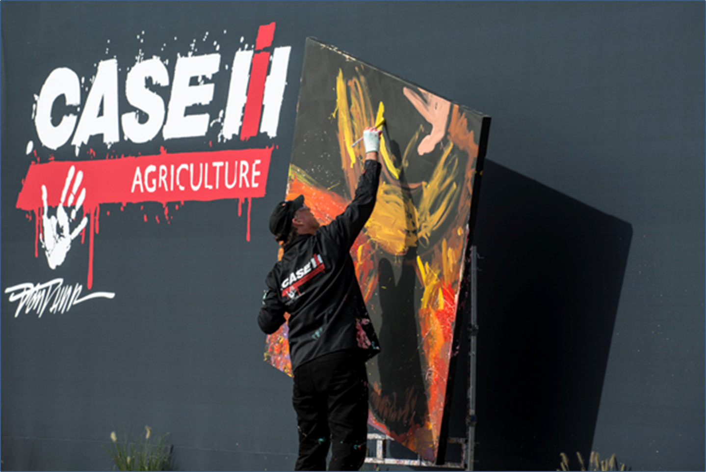Dan Dunn, Paintjam speed painter, creates a painting commemorating “Year of the Farmer” during the Case IH arena show
