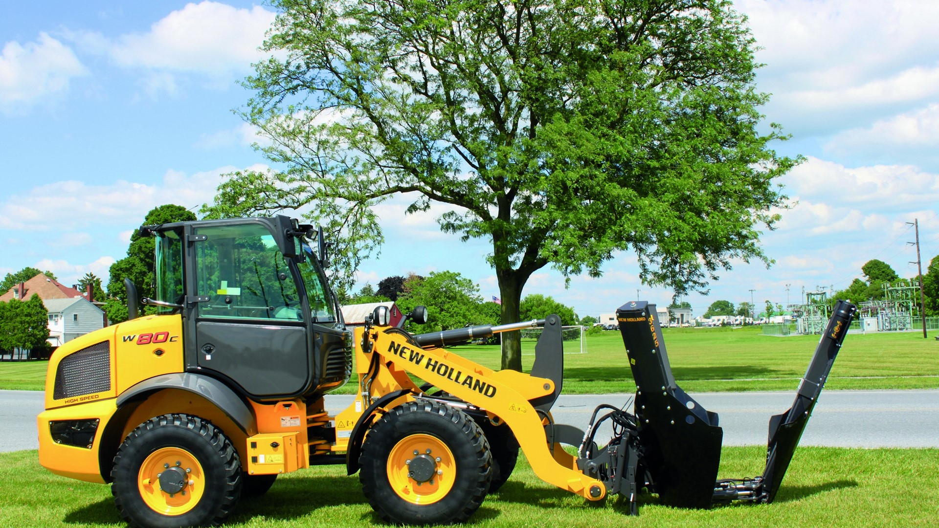 New Holland Construction with a tree removal implement