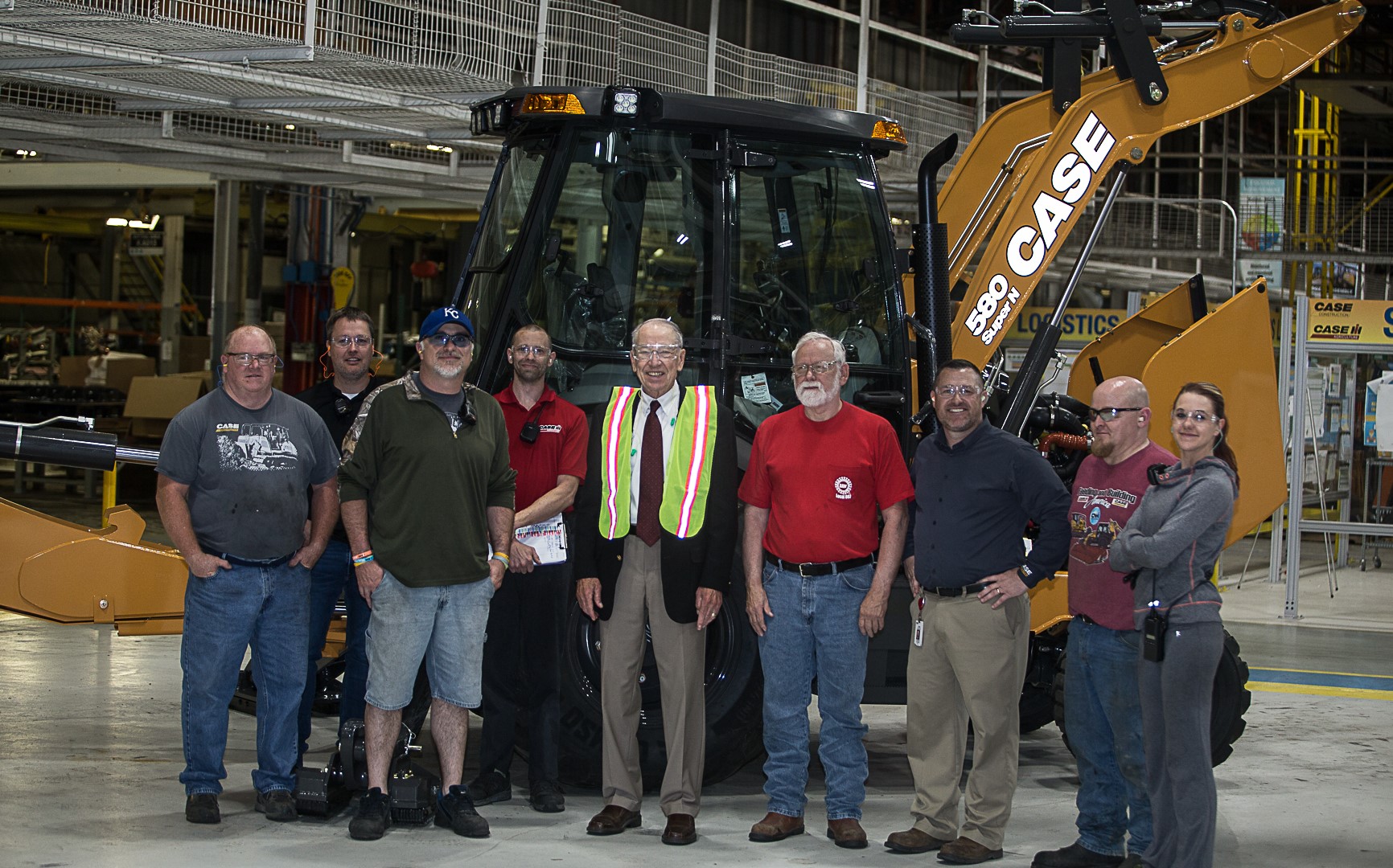 U.S. Senator Chuck Grassley surrounded by employees at the CASE Construction Equipment Burlington Plant