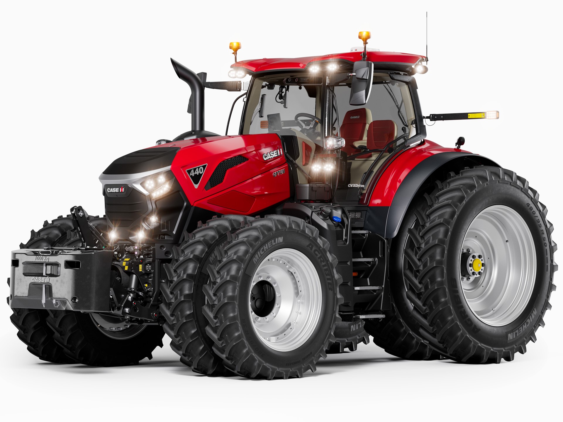 A modern red Case IH 440 tractor with large dual rear tires and dual front tires, featuring a spacious enclosed cabin, front weights, and multiple lights, shown on a white background.