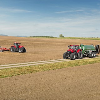 Case IH Optum 300 CVX with a slurry tank on the road and Optum 300 CVX with a disc harrow in the field