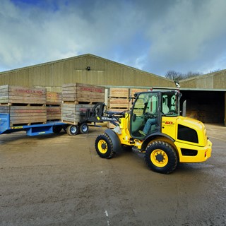 W60C compact wheel loader loading pallets