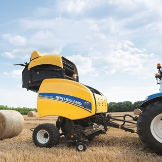 New Holland Roll Belt™ 180 SuperFeed™ ejecting a straw bale