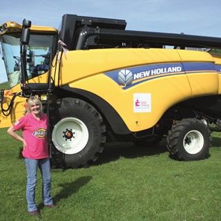 Judi finishes 174-mile journey on a New Holland CX5080 Combine Harvester for cancer charity