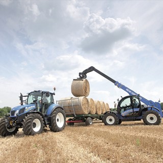 New Holland LM7.35 Telehandler loading bales in the field