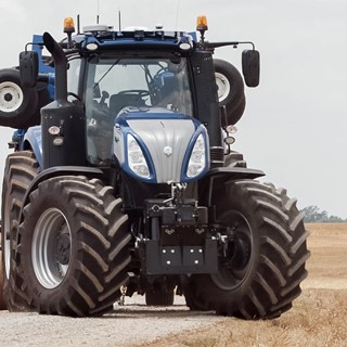 New Holland T8 NHDrive Autonomous Concept Tractor on the road with the New Holland 2085 Air Disc Drill in transport posi