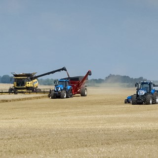 New Holland T8 NHDrive Autonomous Concept Tractor with the 2085 Air Disc Drill alongside a CR Combine and a T8 SmartTrax