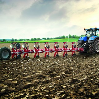 A New Holland tractor working with a plough