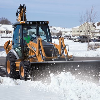 Auxiliary hydraulics help backhoes power attachments, such as snow blowers and brushes