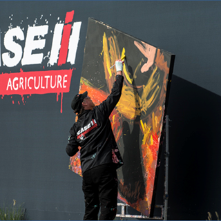 Dan Dunn, Paintjam speed painter, creates a painting commemorating “Year of the Farmer” during the Case IH arena show