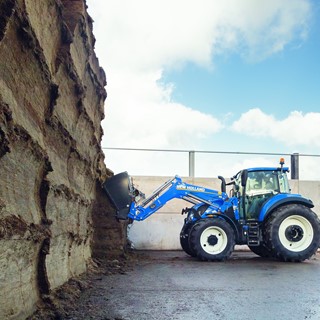 T5.120 working in a silage clamp