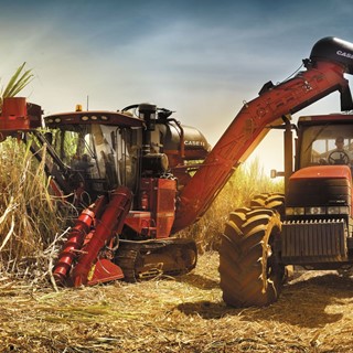 Case IH sugarcane harvester and tractor at work in the field