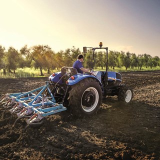 The New Holland TD4F conducting cultivating activities
