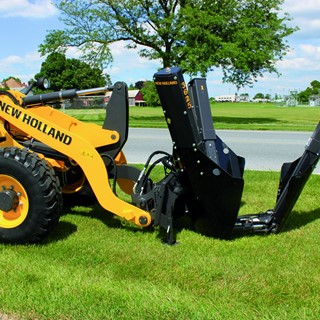 New Holland Construction Wheel Loader with a tree removal implement attached