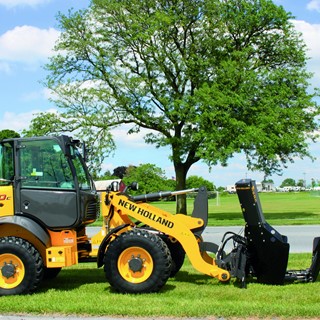 New Holland Construction with a tree removal implement
