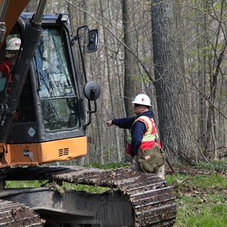 Team Rubicon Heavy Equipment Instructor Shane Pratt directs an excavator operator at a service project in Wisconsin