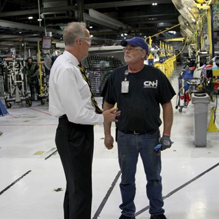 U.S. Senator Jerry Moran speaks with a CNH Industrial plant employee in Wichita, Kansas facility