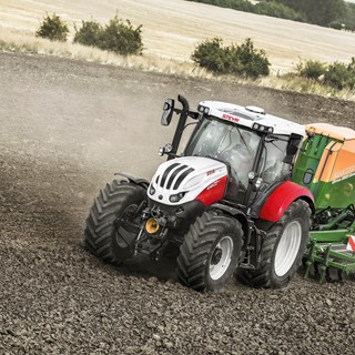 Steyr Profi 4145 CVT Seeder Combination working in a field