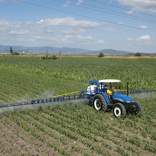 TD90 tractor spraying a field