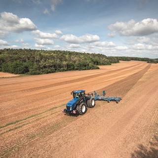The new T9 Auto Command ploughing a field