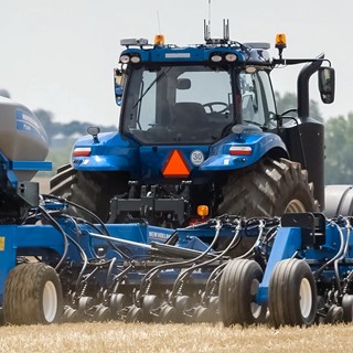 New Holland T8 NHDrive Autonomous Concept Tractor in the field with the New Holland 2085 Air Disc Drill Close Up