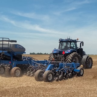 New Holland T8 NHDrive Autonomous Concept Tractor in the field with the New Holland 2085 Air Disc Drill