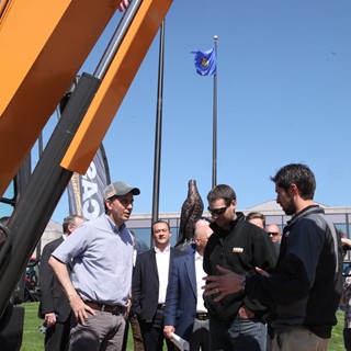 Wisconsin Governor Scott Walker discusses equipment to be used at the Foxconn development with Ed Brenton and Eric Ziese