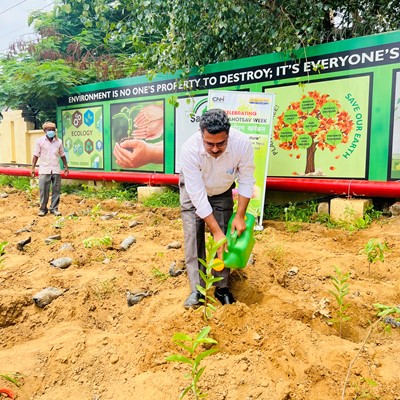 CNH Industrial employee watering plants in Greater Noida