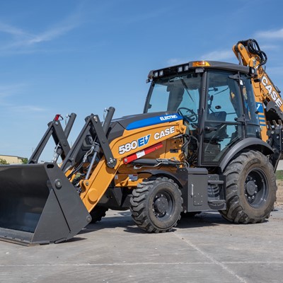 The image shows a yellow and black CASE 580 EV electric backhoe loader parked on a concrete surface with a clear blue sky in the background. The machine features a front loader bucket and a rear digging arm, with large rugged tires suitable for construction work.

 Electric CASE 580 EV backhoe loader with front bucket and rear digging arm parked on concrete under a clear blue sky.