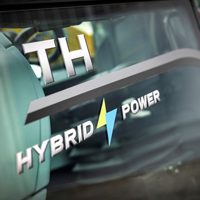 Close-up view of a vehicle window with the text "TH HYBRID POWER" and a yellow and blue lightning bolt symbol, indicating hybrid power technology.