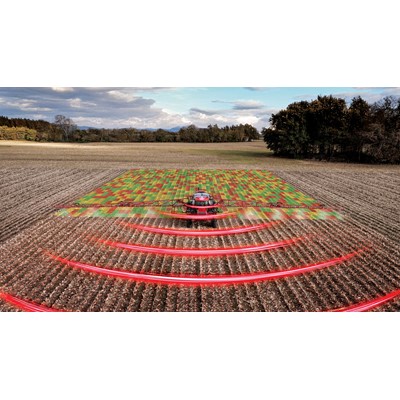 A red agricultural tractor equipped with advanced technology is spraying a field, with a digital overlay showing a colorful grid pattern on the crops and red curved lines representing sensor or radar signals, illustrating precision farming and smart agriculture techniques in a rural landscape under a partly cloudy sky.