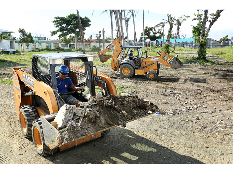 The Case 580SN backhoe loader and SR150 skid steer loader clear out debris on the Bethany Hospital site The Case 580SN backhoe loader and SR150 skid steer loader clear out debris on the Bethany Hospital site