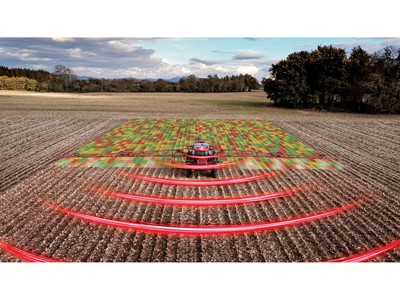 A red agricultural tractor equipped with advanced technology is spraying a field, with a digital overlay showing a colorful grid pattern on the crops and red curved lines representing sensor or radar signals, illustrating precision farming and smart agriculture techniques in a rural landscape under a partly cloudy sky.