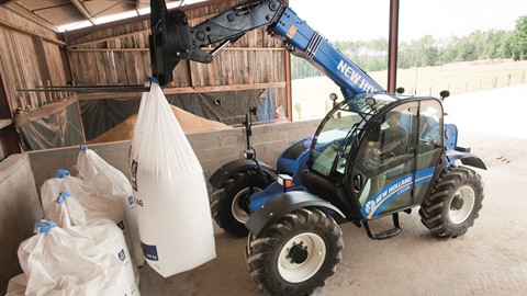 New Holland LM7.35 Telehandler moving fertilizer bags