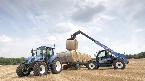 New Holland LM7.35 Telehandler loading bales in the field