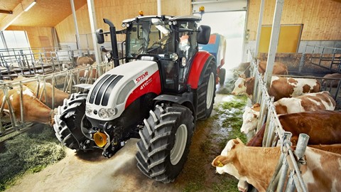 Steyr 4110 Multi Tractor with a feeder wagon