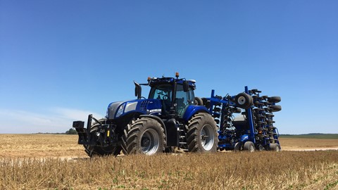 New Holland T8 NHDrive Autonomous Concept Tractor on the road with the 2085 Air Disc Drill in transport position