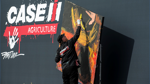 Dan Dunn, Paintjam speed painter, creates a painting commemorating “Year of the Farmer” during the Case IH arena show