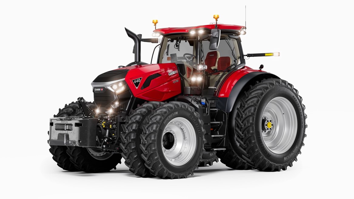 A modern red Case IH 440 tractor with large dual rear tires and dual front tires, featuring a spacious enclosed cabin, front weights, and multiple lights, shown on a white background.
