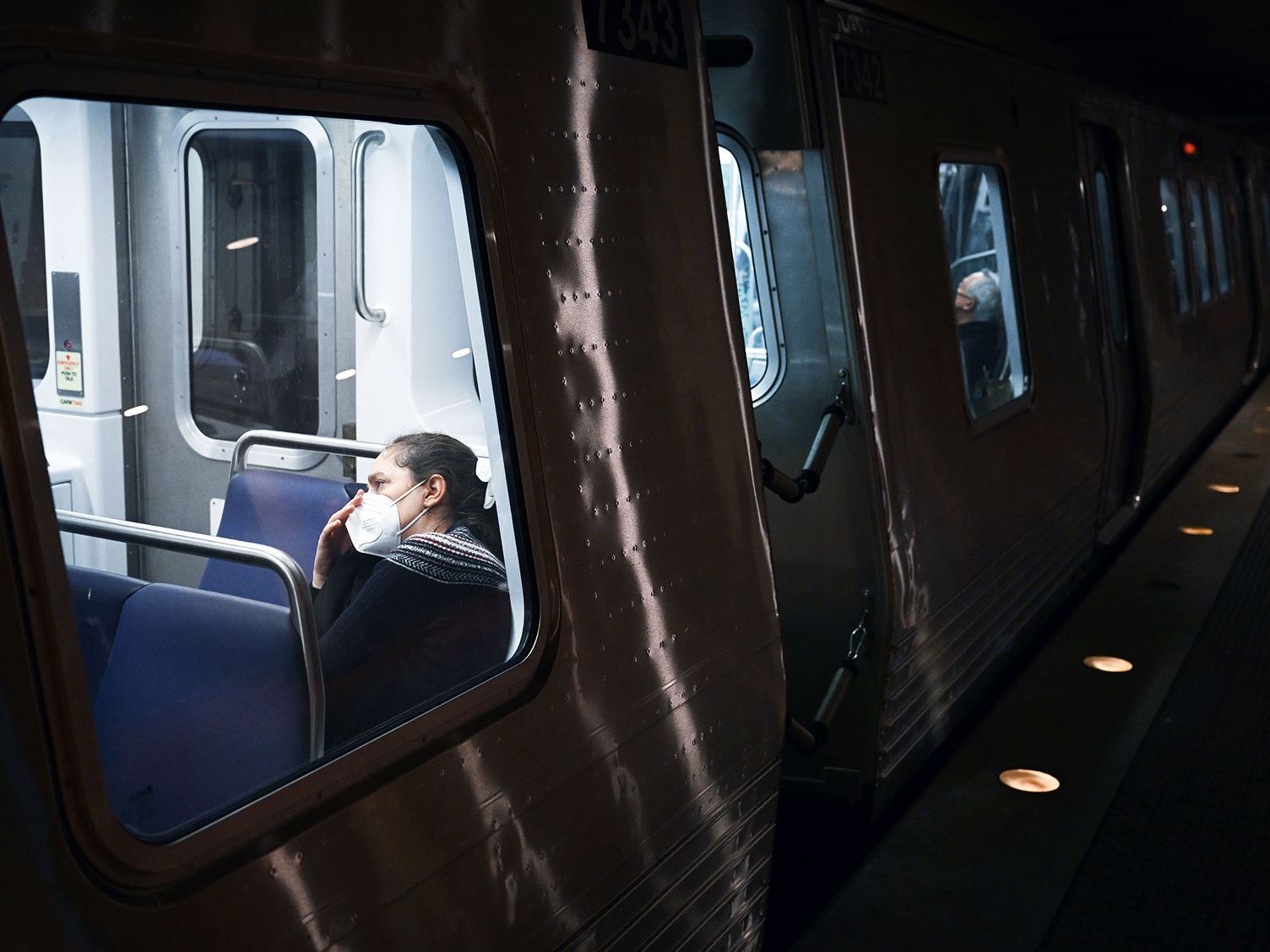 A passenger wears a mask while riding a train passing through the Metro Center station on Thursday January 04 2024 in W
