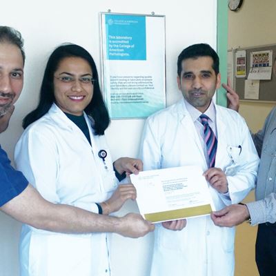 The SKGH laboratory management team (from left to right): Jameel Abulaban, BSc, MSc; Divya Tripathi, MD, MBBS; Mubarak A