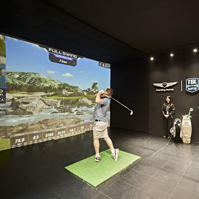 A FAN TRIES OUT THE TGL SWING SIMULATOR AT THE FAN VILLAGE OF THE 2025 GENESIS CHAMPIONSHIP IN CHEONAN KOREA