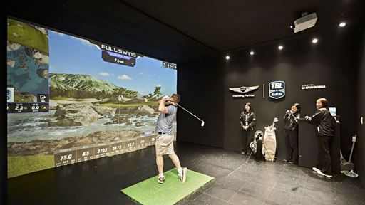 A FAN TRIES OUT THE TGL SWING SIMULATOR AT THE FAN VILLAGE OF THE 2025 GENESIS CHAMPIONSHIP IN CHEONAN KOREA