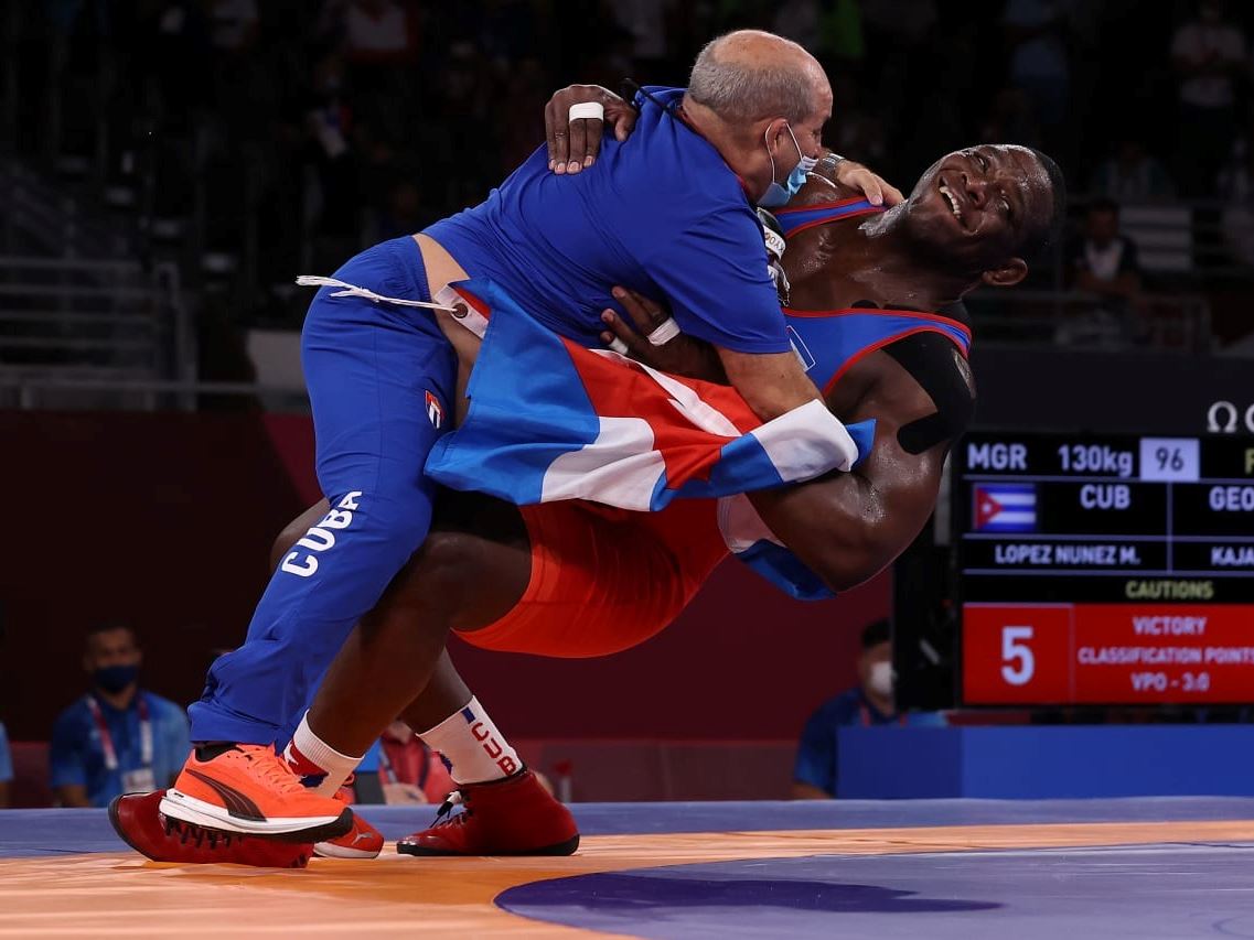 CHIBA JAPAN AUGUST 02 Mijain Lopez Nunez of Team Cuba celebrates with his coaching staff after defeating Iakobi Kaja