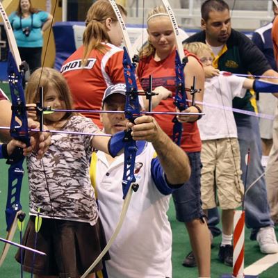 Children practice archery during the Olympic Day in Los Angeles